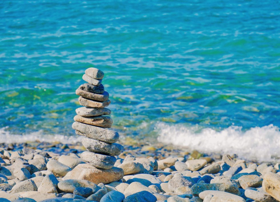 stacked stones balancing by water