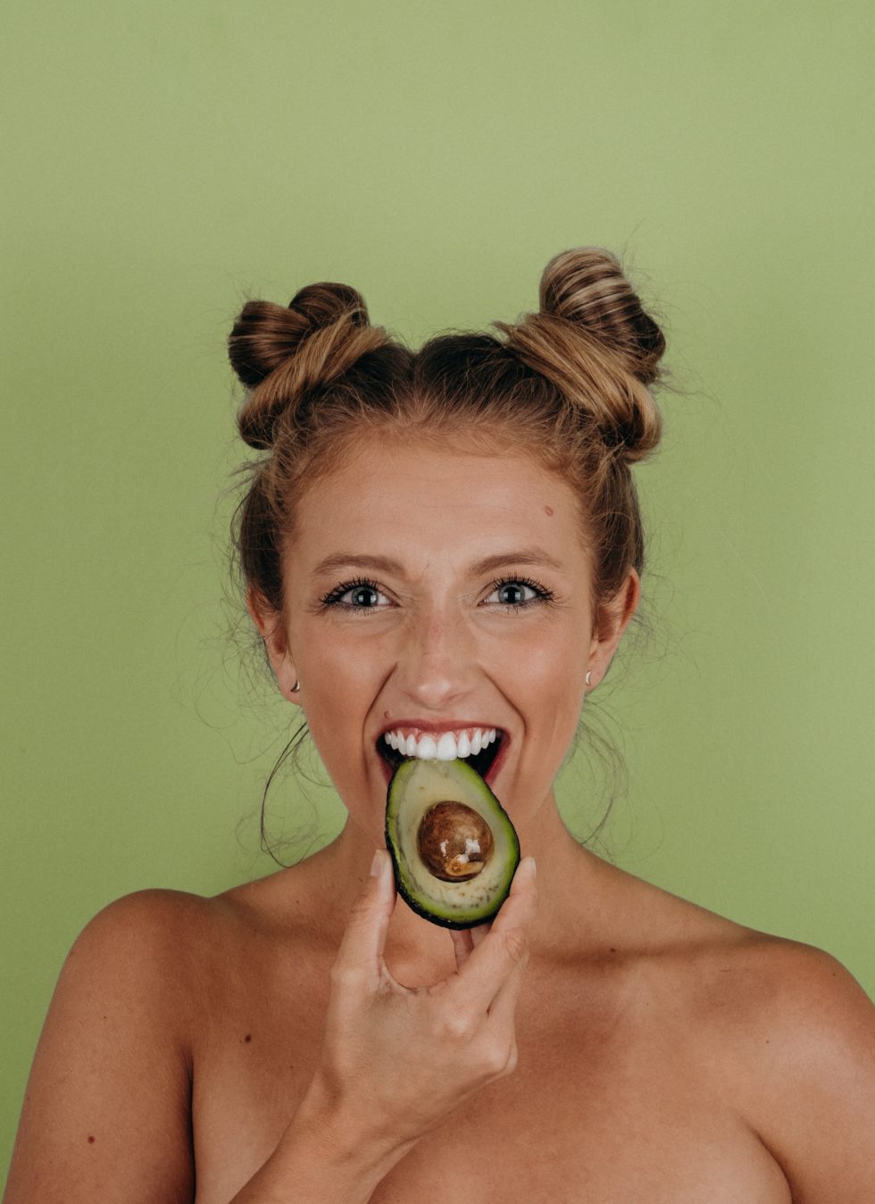 woman eating avocado